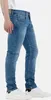A person wearing blue jeans and white sneakers, shown from the side. Produktbild-Vorschau