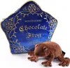 A plush chocolate frog toy is placed next to a plush pillow shaped like a chocolate frog box. Podgląd zdjęcia produktu