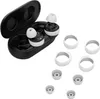 A pair of white and black wireless earbuds with their charging case and several silicone ear tips and rings are displayed on a white background. Podgląd zdjęcia produktu