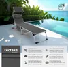 A lounge chair is placed on a patio next to a swimming pool with a tropical background. Náhled obrázku produktu