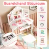 A child's white vanity table with a tri-fold mirror and accessories, set in a room with pink accents. Anteprima dell’immagine prodotto