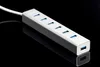 A silver USB hub with multiple ports is shown on a reflective black surface. Voir les images du produit