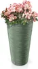 A green planter with pink and white flowers. Voir les images du produit