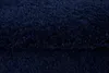 A close-up, textured view of a dark blue rug. Voir les images du produit