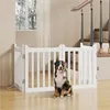 A dog sits in front of a white wooden pet gate in a home setting, with stairs visible in the background. Podgląd zdjęcia produktu
