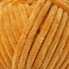 A close-up, textured view of orange yarn. Podgląd zdjęcia produktu