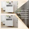 A collage of two images showing a white cabinet with glass doors and drawers, with a text overlay about color differences. Podgląd zdjęcia produktu