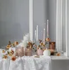 A collection of LED candles and decorative elements arranged on a lace tablecloth. Produktbild-Vorschau