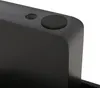 A close-up view of the corner of a black furniture item, showing a small circular rubber foot and a hole. Voir les images du produit