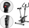 A stationary exercise bike with close-up views of its console and resistance knob. Produktbild-Vorschau