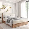 A bedroom with a large bed, artwork on the wall, and a window with curtains. Voir les images du produit