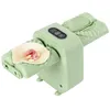 A light green automatic dumpling maker with a piece of dough and filling on one side. Produktbild-Vorschau