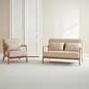 A beige armchair and a beige loveseat are placed in a room with white doors and a light-colored wall. Anteprima dell’immagine prodotto