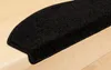 A close-up shot of a black stair mat on a wooden staircase. Produktbild-Vorschau