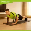 A man is doing push-ups with resistance bands in a room. Produktbild-Vorschau