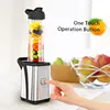 A hand pressing a button on a personal blender, with fruit in the blender cup and a bowl of apples in the background. Produktbild-Vorschau