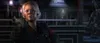 A woman in a military uniform holds a gun and looks at the camera. Produktbild-Vorschau