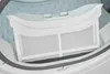 Close-up of a white dryer lint filter inside a washing machine drum. Produktbild-Vorschau
