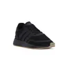 A black Adidas sneaker with a tan sole is shown against a white background. Produktbild-Vorschau