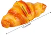 A close-up of a realistic-looking croissant with measurement lines indicating its size. Podgląd zdjęcia produktu