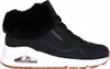 A side view of a black Skechers sneaker with a white sole and a brown outsole. Voir les images du produit
