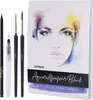 A watercolor paper block and art supplies are laid out on a white background. Produktbild-Vorschau