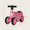 A pink balance bike with leopard print details, shown with dimensions indicated by measurement lines and text. Náhled obrázku produktu