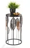 A decorative side table with a plant and a bowl of decorative items on top. Produktbild-Vorschau