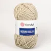 A ball of beige yarn with a label. Produktbild-Vorschau