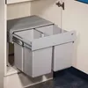 A pull-out trash bin with two compartments inside a cabinet. Produktbild-Vorschau