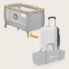 A travel crib and a suitcase are shown, with an arrow indicating the crib can be packed into the suitcase. Produktbild-Vorschau