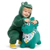 A child in a green dinosaur costume is playing with a green inflatable dinosaur toy. Podgląd zdjęcia produktu