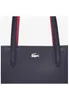 Close-up of a dark blue leather handbag with red accents on the straps and a silver crocodile logo. Anteprima dell’immagine prodotto