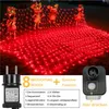 A red net light decoration with golden mouse figures, shown outdoors at night. Produktbild-Vorschau