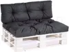 A dark gray tufted cushion set on a white wooden pallet base. Voir les images du produit