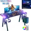 A gaming desk setup with a computer, monitor, keyboard, mouse, and headphones, all illuminated by LED lights. Produktbild-Vorschau