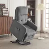 A gray recliner chair is shown in a living room setting, next to a bookshelf and a dresser. Náhľad obrázku produktu