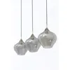 Three glass pendant lights hanging against a white background. Produktbild-Vorschau