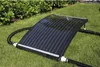A solar collector for a pool is placed on a grassy lawn next to some bushes. Podgląd zdjęcia produktu