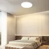 A modern bedroom with a large bed and a ceiling light. Voir les images du produit