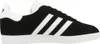 A side view of a black Adidas Gazelle sneaker with white stripes and sole. Produktbild-Vorschau