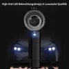 Schwarzer Auto-Lufterfrischer mit blauem LED-Licht, vor einem unscharfen Auto mit eingeschalteten Scheinwerfern Náhľad obrázku produktu