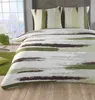 A bed with bedding and pillows in a room with a window showing a snowy landscape. Produktbild-Vorschau