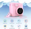 A pink LAMAX InstaKid1 camera is shown with various feature icons below it. Anteprima dell’immagine prodotto