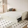 A cream-colored sofa bed is shown in a room with a floor lamp and a patterned rug. Produktbild-Vorschau