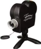 A black projector shaped like a vintage camera, mounted on a black tripod. Náhled obrázku produktu