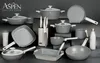 A collection of kitchenware, including pots, pans, knives, and a mug, arranged on a dark surface. Anteprima dell’immagine prodotto