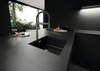 A modern, dark-themed kitchen with a sleek sink and faucet. Produktbild-Vorschau
