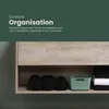 A shelf in a cabinet with rolled up black towels, a green storage basket, and folded white and black towels. Produktbild-Vorschau