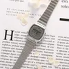 A silver Casio digital watch is placed on a background of text and dried flowers. Podgląd zdjęcia produktu
